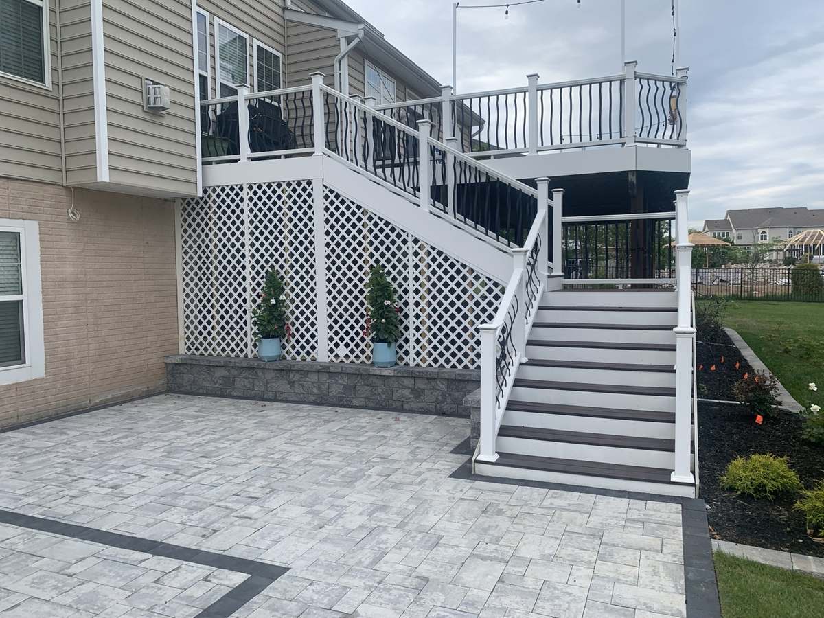 Completed deck, stairs, railings, patio, and landscape improvements